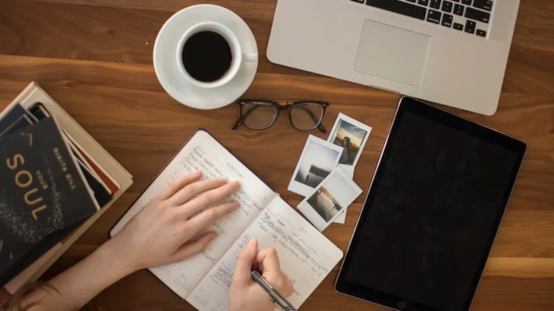 Desk with a notebook, coffee, and laptop — a guide to the French conditionnel présent